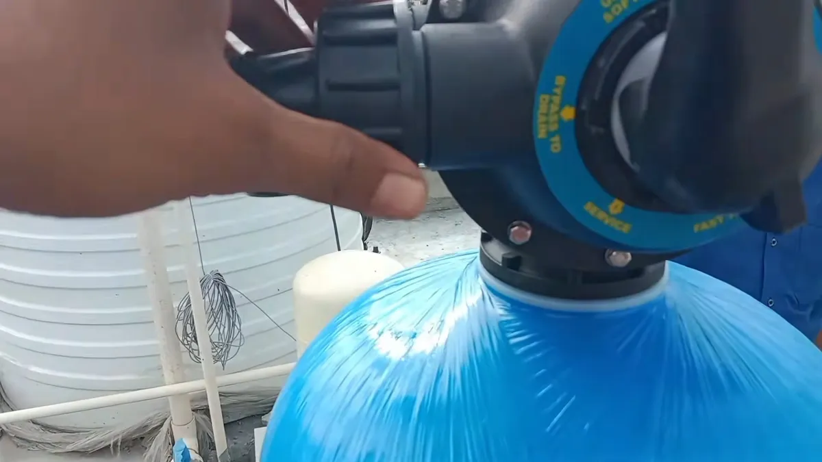 Water softener control head mounted on a blue resin tank during plumbing service in Asante, Surprise, AZ