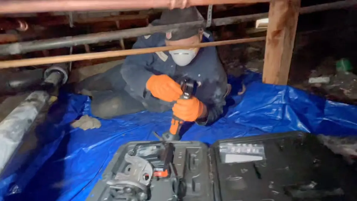 Crawlspace plumbing with drain and supply lines below the floor during emergency plumber in surprise, az, with focus on crawlspace drain supply lines below