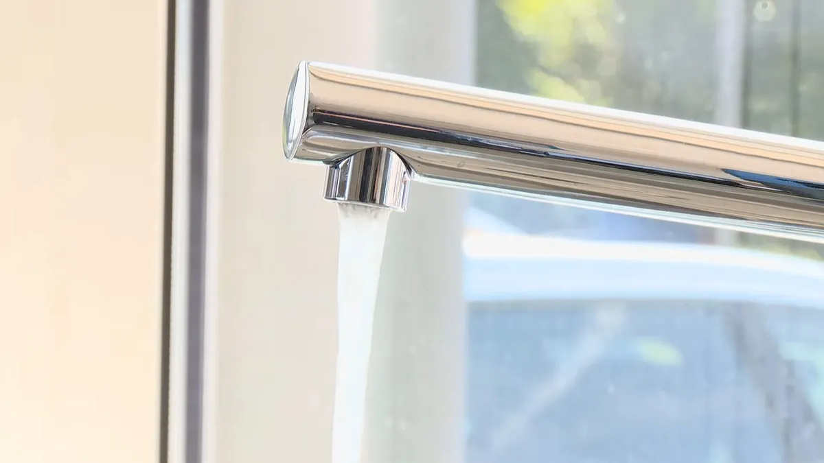 Modern chrome kitchen faucet mounted beside a bright window during faucet repair & replacement in surprise, az