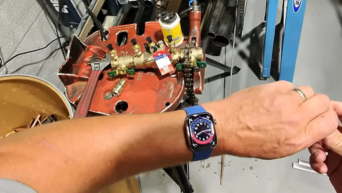 Gas line valve and water heater piping connection being checked during gas line repair & installation in surprise, az