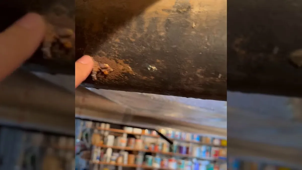 Corroded cast iron pipe section with visible rust and buildup during plumbing service in Glendale