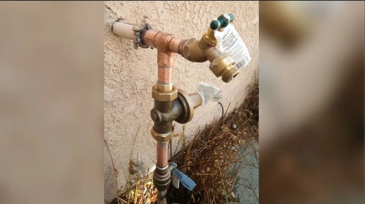 Outdoor hose bib and wall faucet connection being checked during repair in Surprise during hose bib repair & replacement in surprise, az