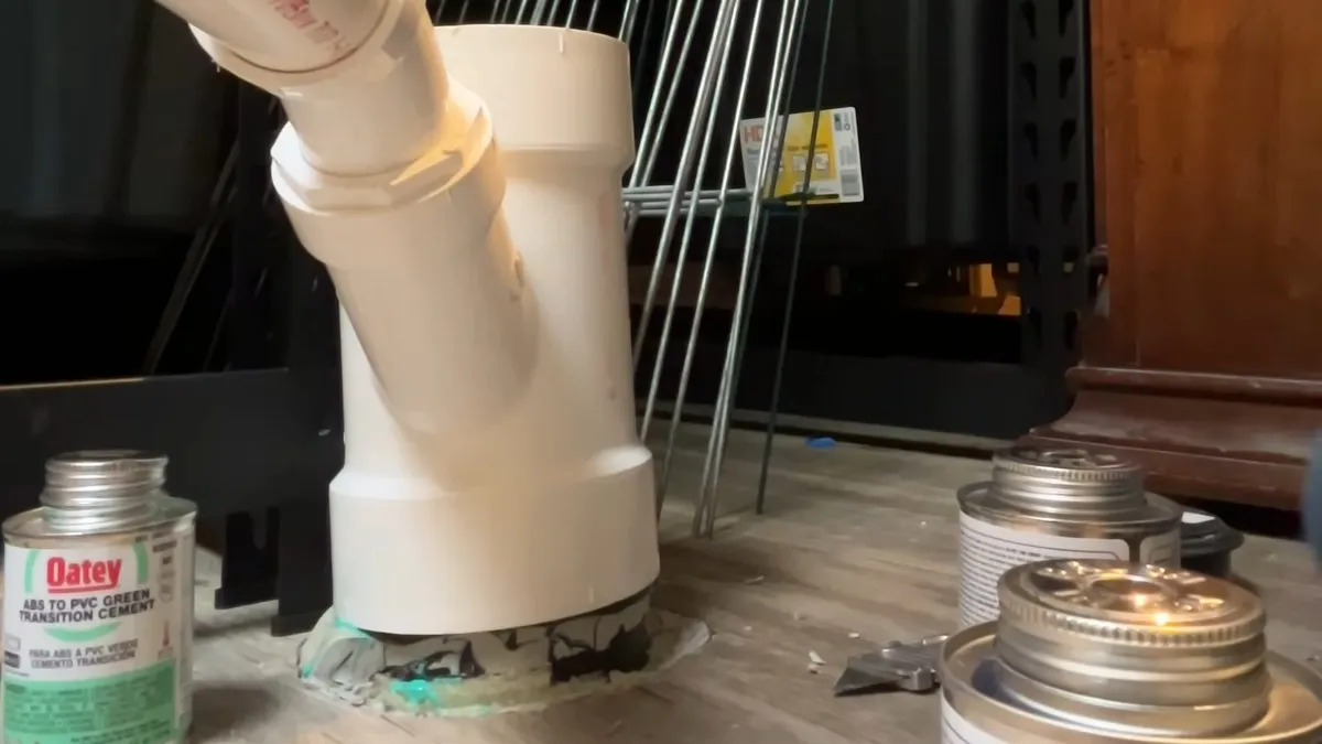 White PVC drain and disposal connections assembled beneath a kitchen sink during kitchen plumbing & remodel in surprise, az