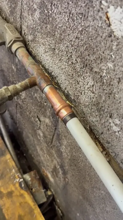 Copper-to-PEX transition connection secured against a wall illustrating monsoon plumbing prep guide for surprise, az homes
