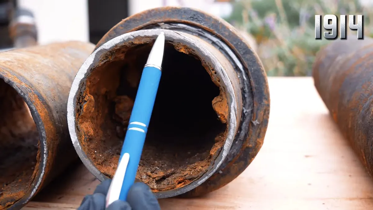 Corroded cast iron pipe section with visible rust and buildup during plumbing service in Original Surprise, AZ