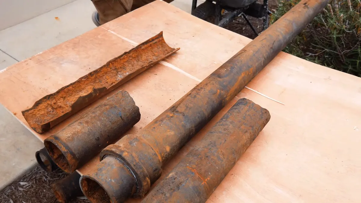 Corroded cast iron pipe section with visible rust and buildup illustrating original surprise repiping: what 1960s homes need now