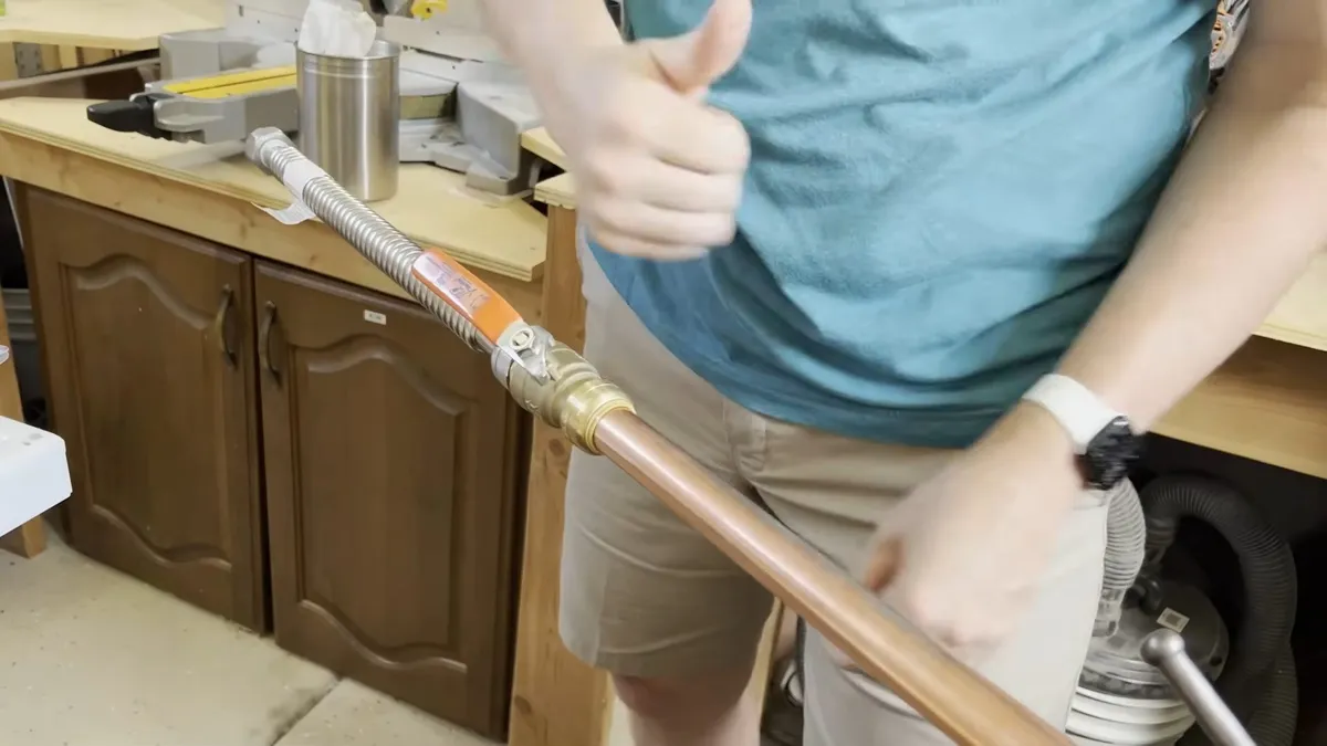 Technician joining blue PEX tubing to a copper pipe with a press connection illustrating original surprise repiping: what 1960s homes need now