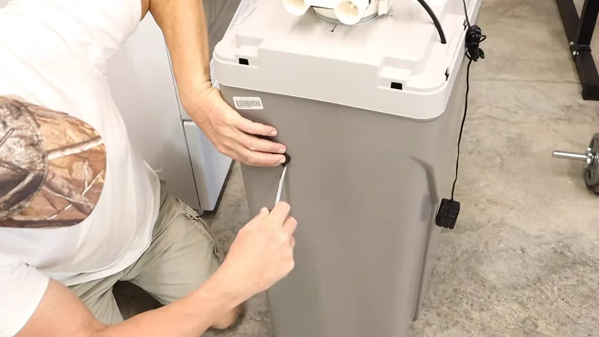 Whole-house water softener with control valve and resin tank during plumbing service in Peoria