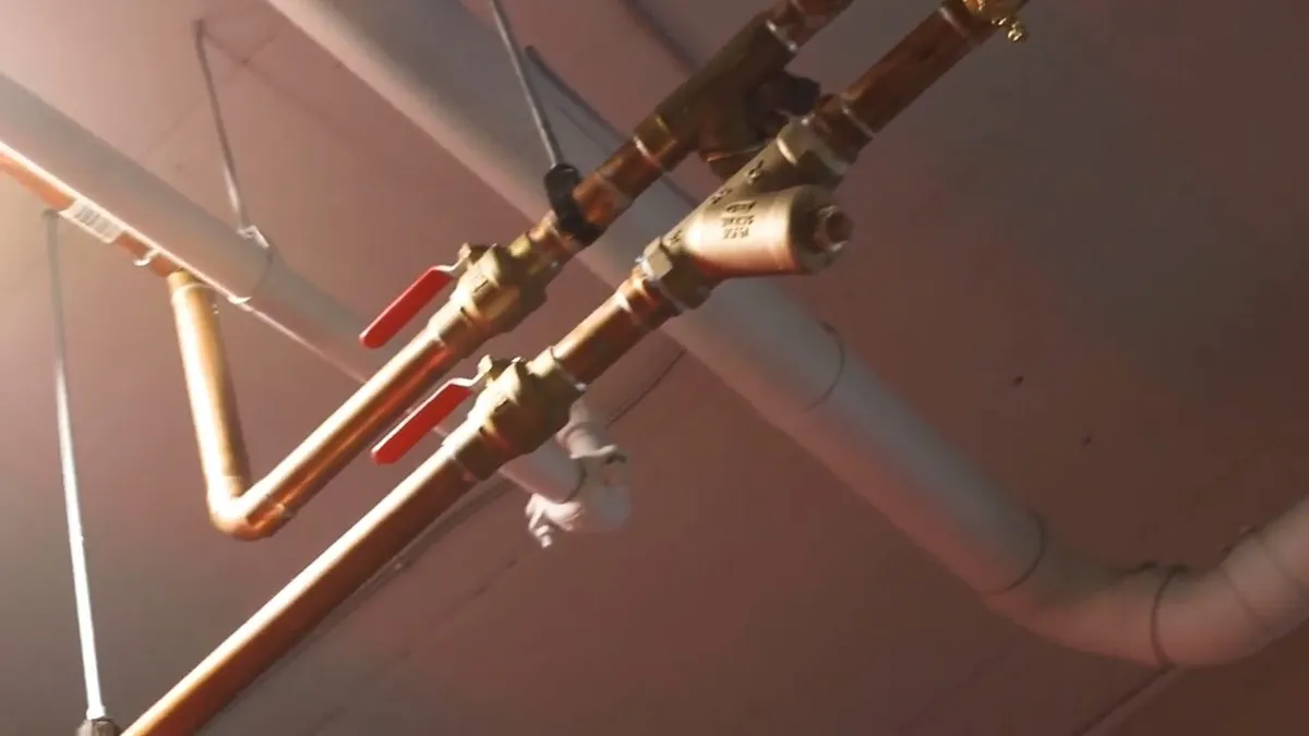 New PEX and copper pipe connections being installed during a repipe during whole-home repiping in surprise, az