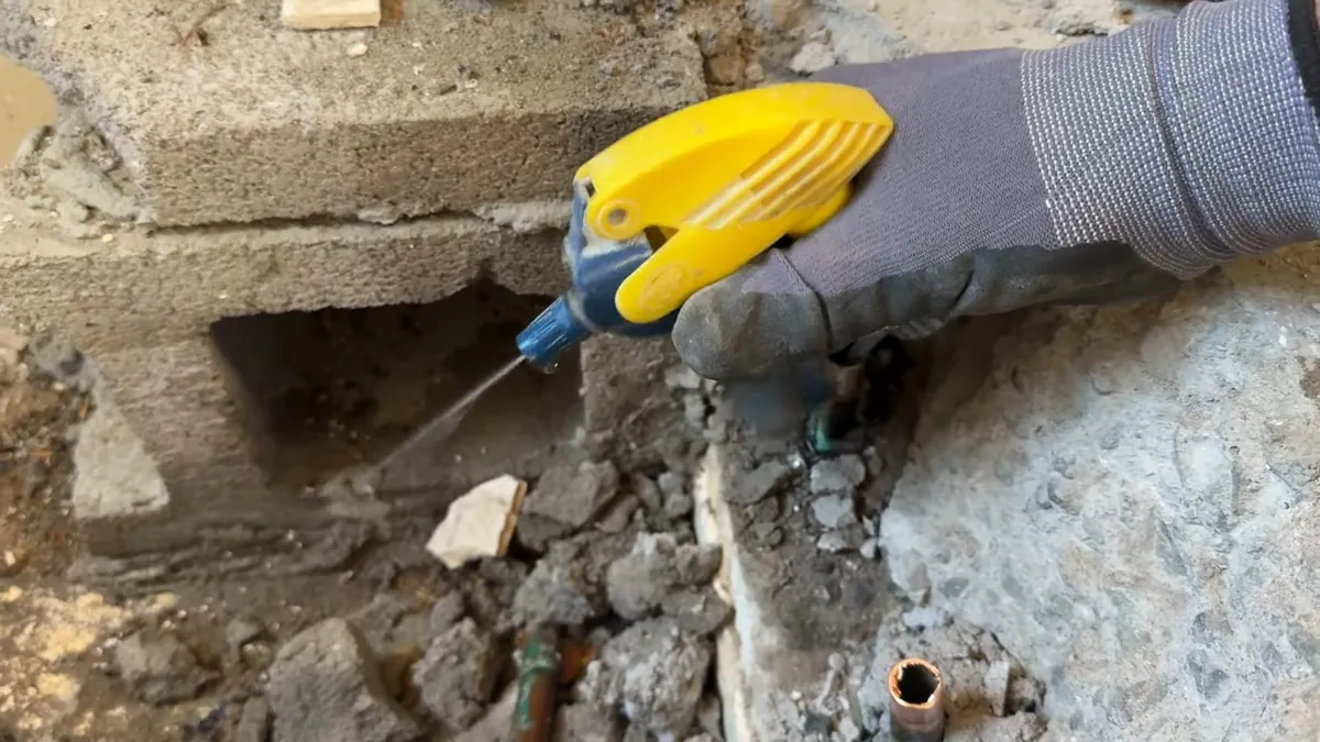 Technician using leak detection equipment around hidden plumbing illustrating slab leak warning signs in surprise az