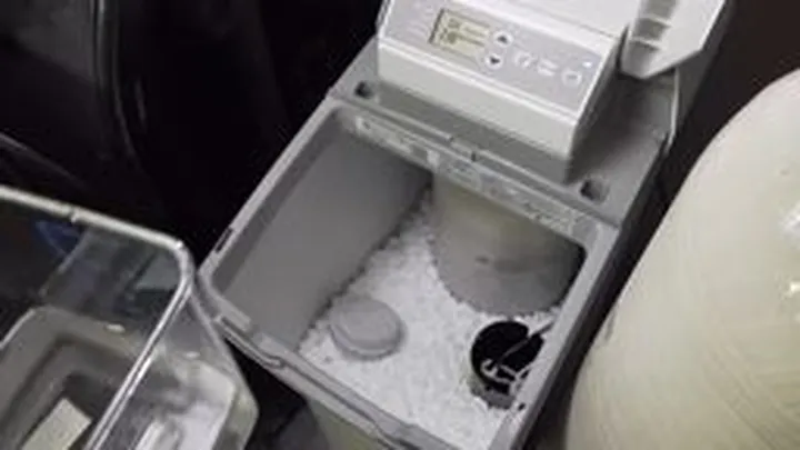 Open water softener brine tank with salt and service parts visible featured with hard water in surprise: what cap colorado river water means for your pipes guidance for Surprise homeowners