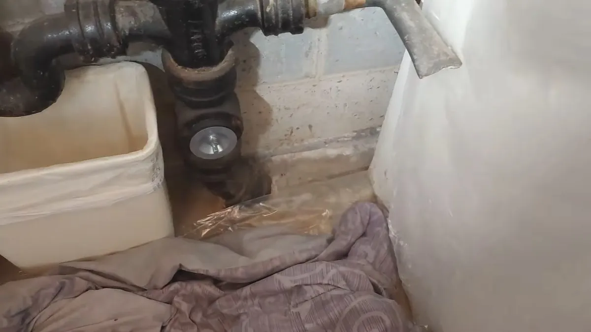 Corroded cast iron pipe section with visible rust and buildup during plumbing service in Youngtown